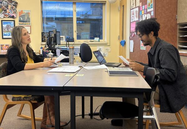 Eastmont Junior High English teachers John Bush and Heidi Barnes collaborate during planning time to design a student-choice research project connected to Unbroken.