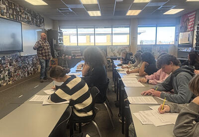 John Schmauder leads AP U.S. History students in analyzing historical claims and evidence, helping students build critical thinking skills in a college-level learning environment.