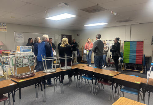 Facilities Planning Committee members meet inside a portable classroom at Kenroy Elementary during a recent school visit, where they toured buildings, reviewed conditions firsthand, and discussed long-term facility needs.