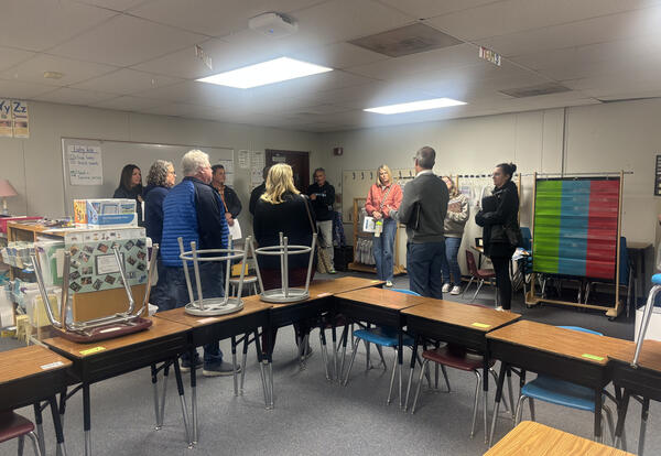 Facilities Planning Committee members meet inside a portable classroom at Kenroy Elementary during a recent school visit, where they toured buildings, reviewed conditions firsthand, and discussed long-term facility needs.