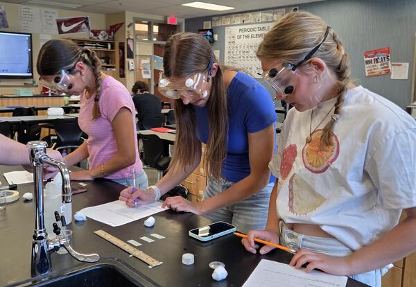Eastmont High School students design and conduct their own chemistry experiments while investigating how different liquids evaporate at different rates during a College in the High School lab activity.