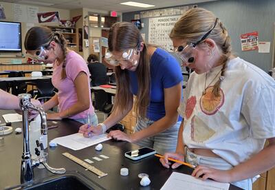 Eastmont High School students design and conduct their own chemistry experiments while investigating how different liquids evaporate at different rates during a College in the High School lab activity.
