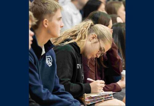 Students Listening and Taking Notes in Chapel