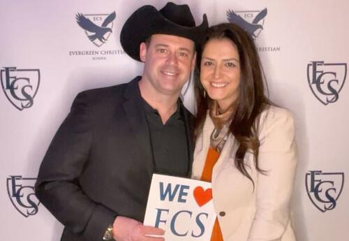 Couple holding a Sign that says We Love ECS