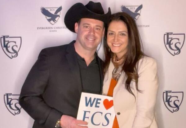 Couple holding a Sign that says We Love ECS