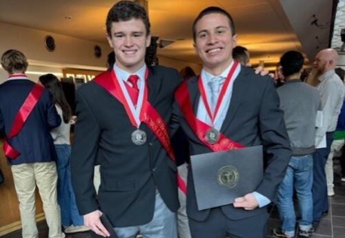 Alumnus Wearing a Sash at Awards Ceremony