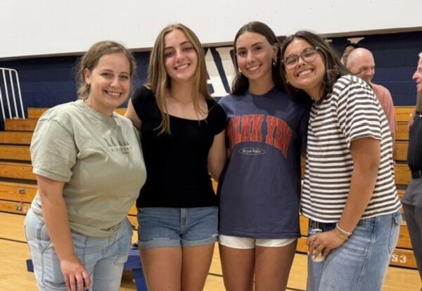 four women posing for camera
