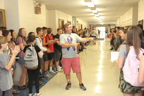 Staff and students in hallway