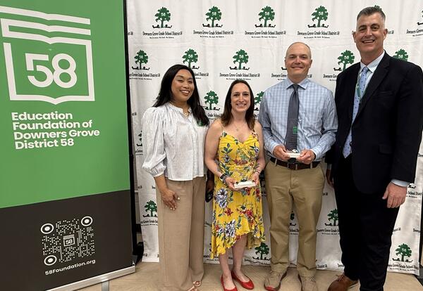 Award winners standing with administrators in front of Downers Grove District 58 and Education Foundation backdrops