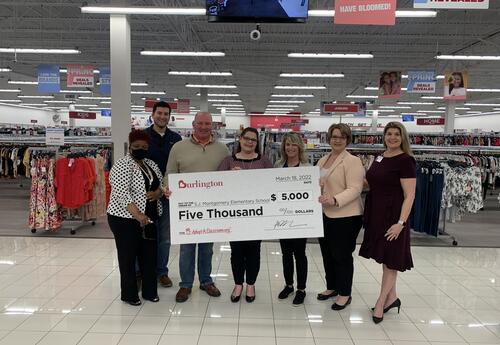 S.J. Montgomery Principal Shauna LeBlanc receiving $5,000 check from AdoptAClassroom and Burlington