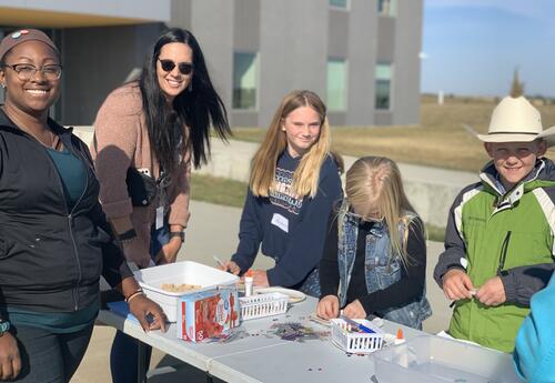 Teacher and students doing activities outside
