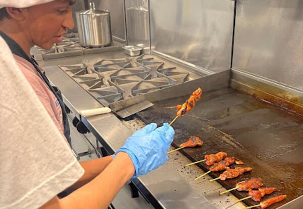 Student grilling meat