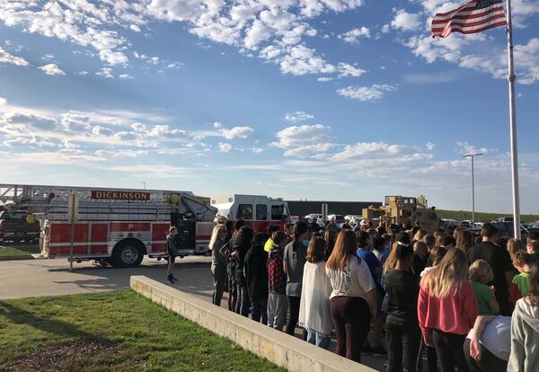 Students standing around flagpole