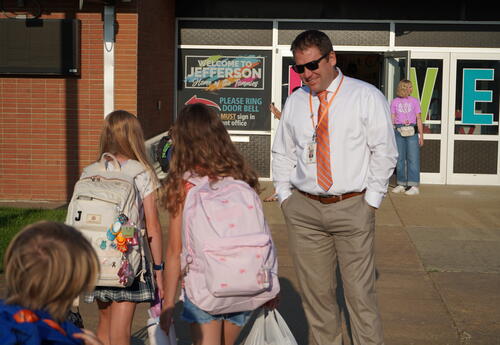 Picture of Dr. Lewton greeting children before school