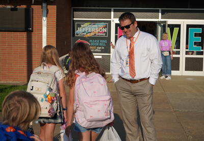 Picture of Dr. Lewton greeting children before school