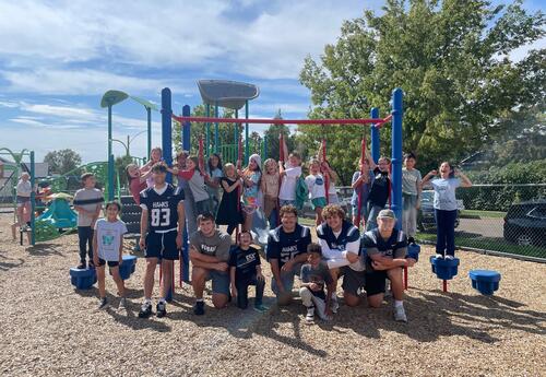 DSU and Roosevelt students pose for a big group picture on the jungle gym