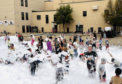 A large group of students celebrating the foam party