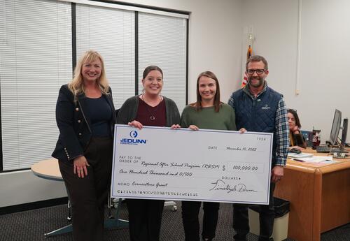 RASP and JE Dunn Representatives smile with large check for 100,000
