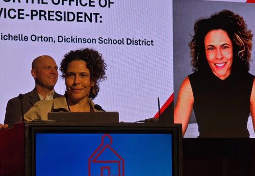 Photo of Michelle Orton on stage being recognized