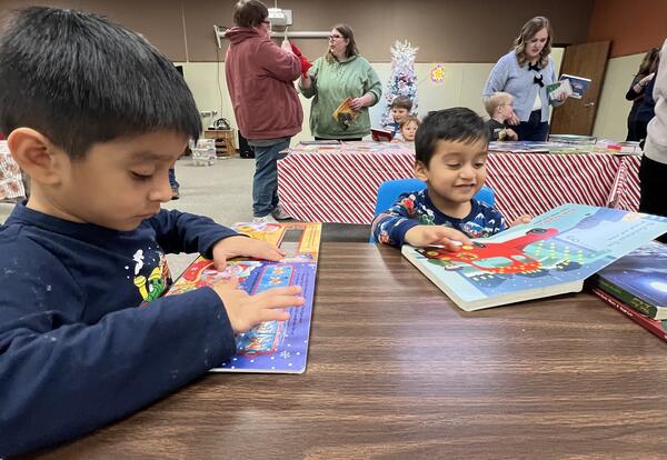 Students reading books at the seasons readings extravaganzza