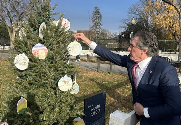 Interior Secretary Doug Burgum looking at North Dakota's tree ornaments