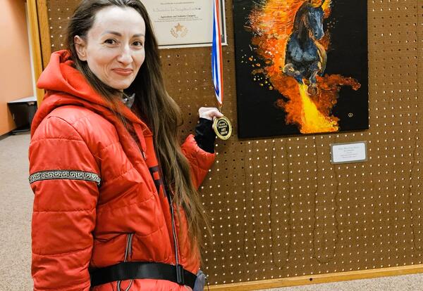 Alina in front of her 1st place winning painting. The painting is of a horse titled “Gray-Blue Fire Horse”