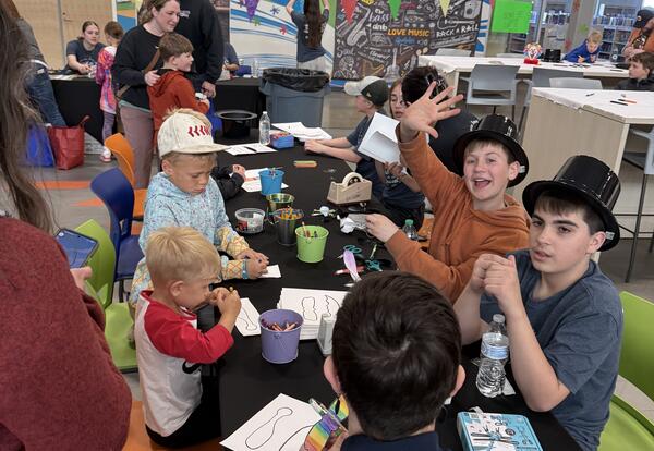 Students at one of the STEAM Carnival stations