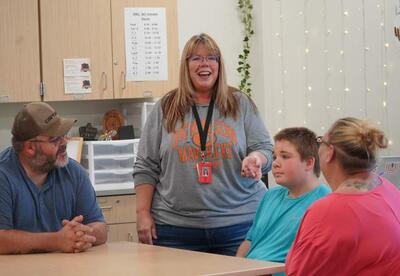 Image of Dawn Weber conversing with a family