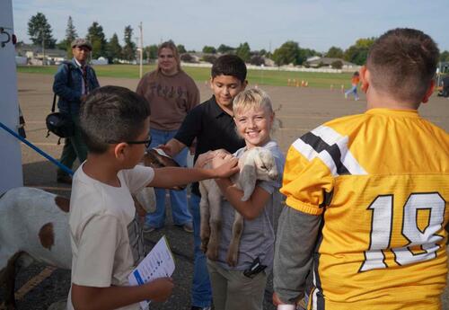 photo of students with a goat