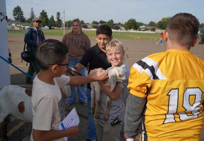 photo of students with a goat