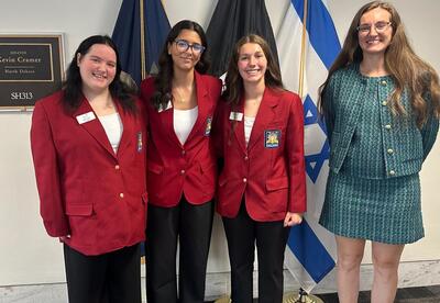 Liz, Alyssa and Emilee posed with state official.
