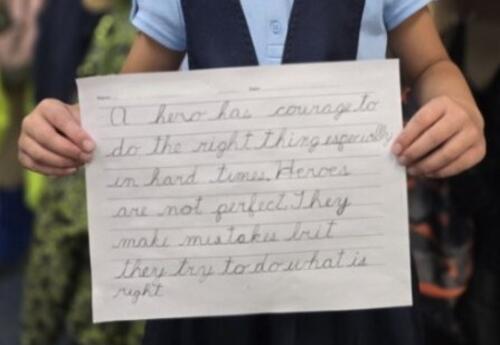 Kindergarten student writing cursive at James Irwin Elementary school