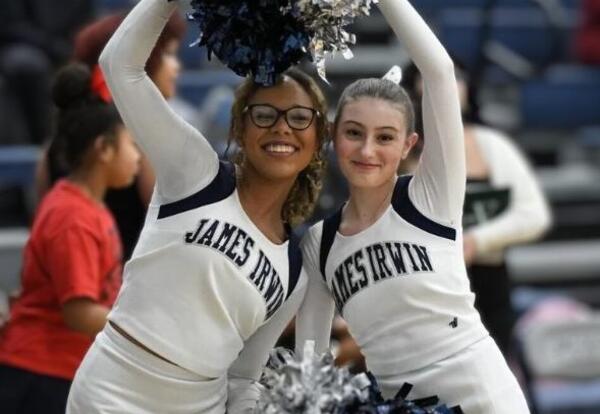 Two students holding pom poms
