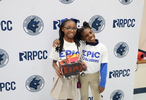 E3 Academy students posing with their food truck project
