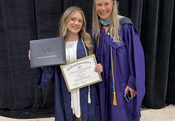 HIT Grad Abigail Clifton celebrates with head of the Health IT program melissa Norris