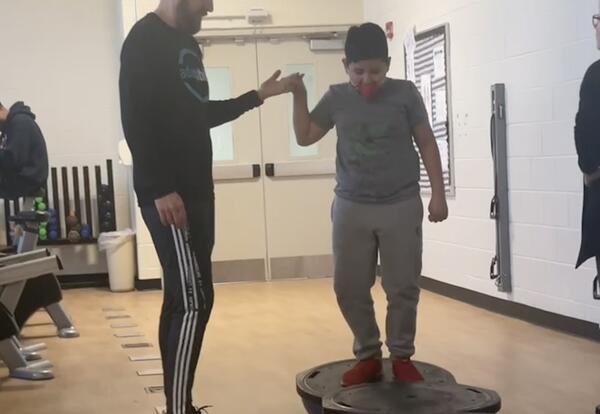 Mr. Snee working with a student during Adaptive PE