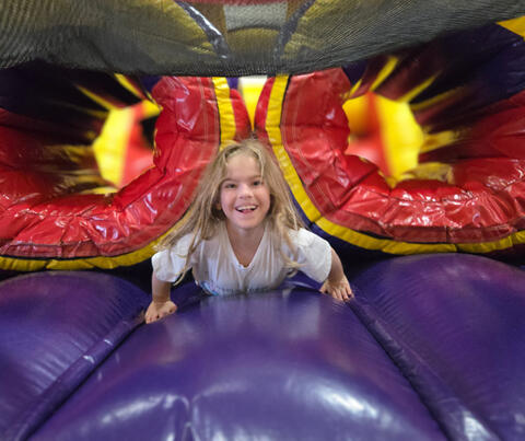 Student smiling on in an inflatable castle