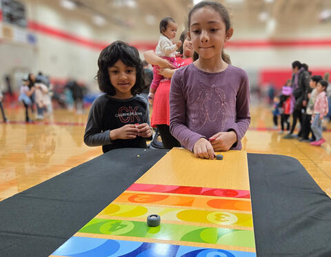 Two Kids playing a carnival game