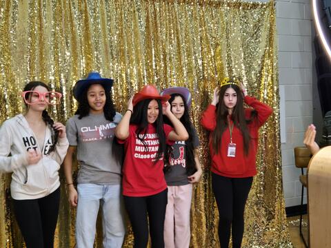 Group of middle school students posing at the photo booth