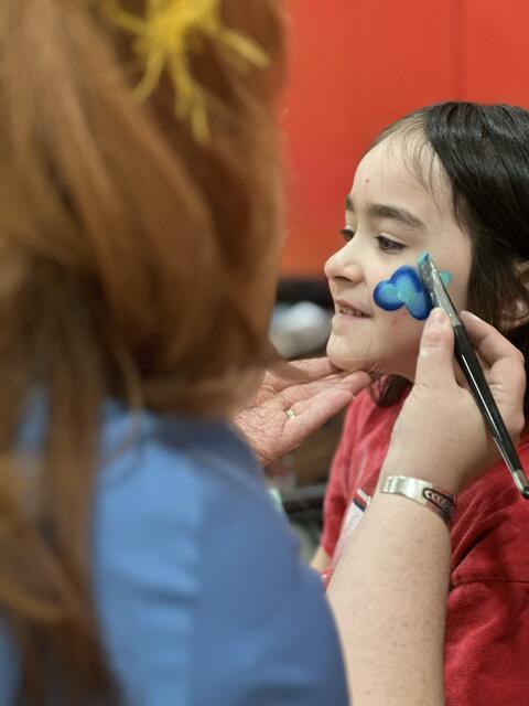 Girl getting her face painted