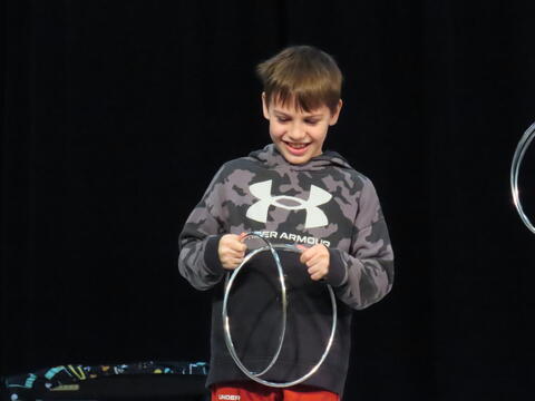 Student Volunteer helping with the magic act