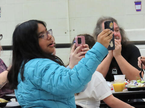 Student Taking a photo of the magic show