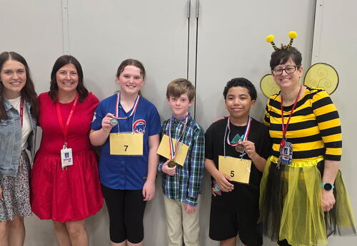 Fifth grade Spelling Bee Finalists: Liam N. (First), Kaitlyn S. (Second) and Bobby R. (Third). Mrs. Moran, Mrs. Doornbos, and Mrs. Kmiec (also pictured)>