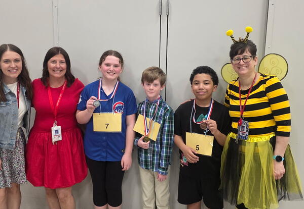 Fifth grade Spelling Bee Finalists: Liam N. (First), Kaitlyn S. (Second) and Bobby R. (Third). Mrs. Moran, Mrs. Doornbos, and Mrs. Kmiec (also pictured)>