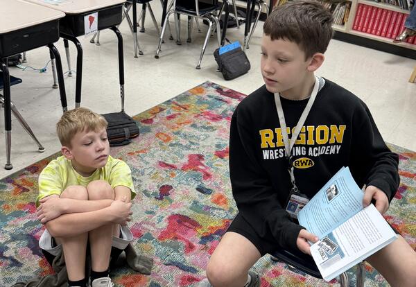 Students reading a book.