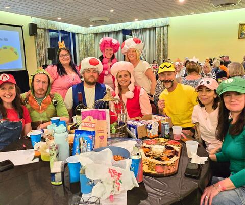 A lively group in Super-Mario-themed costumes