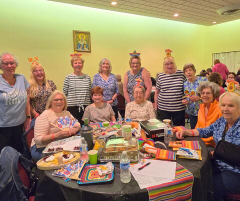 Large group gathered around a table for a picture