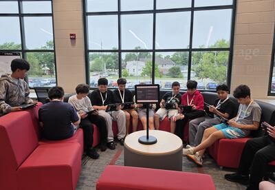 students working on Beast Games challenges together in the library