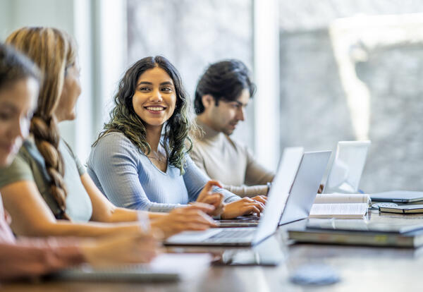 Here is a photo of adults working on laptop computers