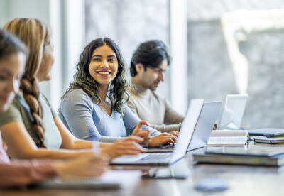 Here is a photo of adults working on laptop computers